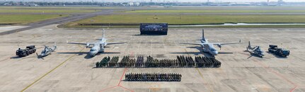 Multinational service members pose for a group photo following the opening ceremony of Super Garuda Shield 2024 at Juanda International Airport, East Java, Indonesia, Aug. 26, 2024. The annual exercise has grown into a combined and joint event focused on commitment to partnership and a free and open Indo-Pacific.