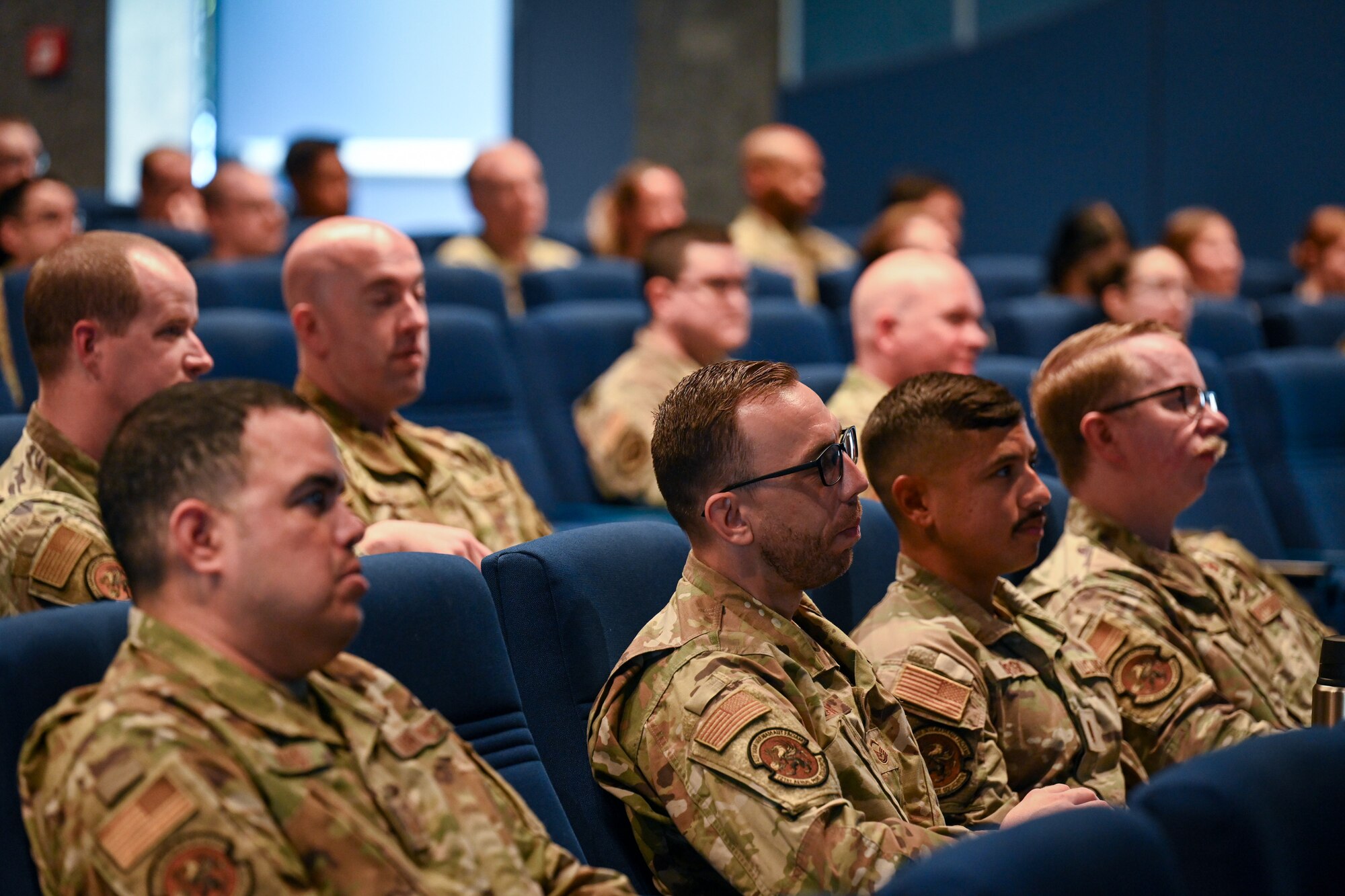 Members assigned to the 521st Air Mobility Operations Wing listen to a Warrior Heart keynote speech from Dr. Jannell MacAulay, a strategic health and human performance specialist, at the Herc Theater on Ramstein Air Base, Germany, August 29, 2024.