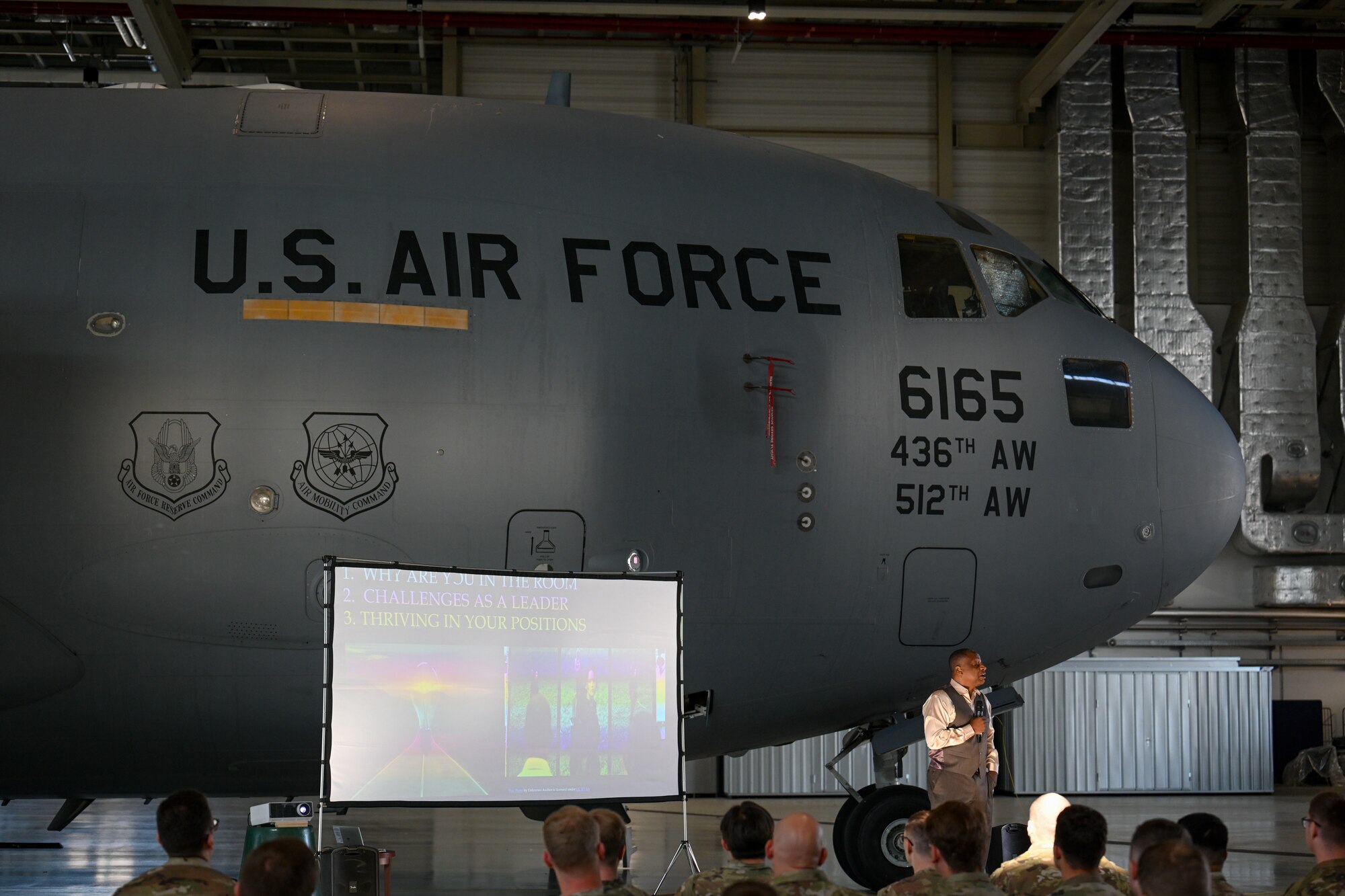Retired U.S. Air Force Chief Master Sgt. Anthony Brinkley teaches Airmen assigned to the 521st Air Mobility Operations Wing about the composition of healthy teams a Warrior Heart keynote speech, August 29, 2024, inside of Hangar 5 on Ramstein Air Base, Germany.