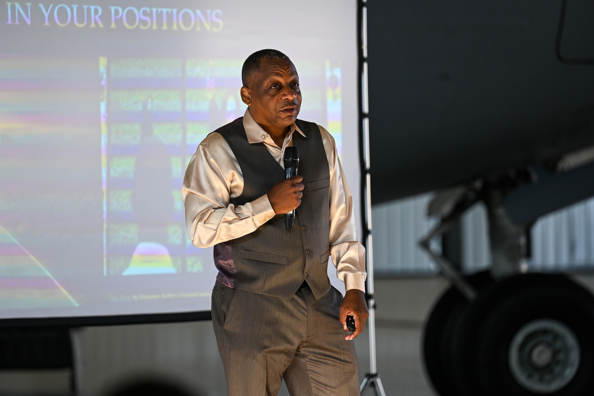 Retired U.S. Air Force Chief Master Sgt. Anthony Brinkley teaches Airmen assigned to the 521st Air Mobility Operations Wing about the composition of healthy teams a Warrior Heart keynote speech, August 29, 2024, inside of Hangar 5 on Ramstein Air Base, Germany.