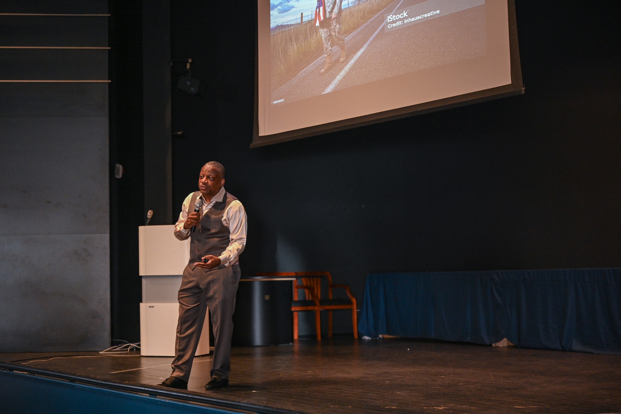 Retired U.S. Air Force Chief Master Sgt. Anthony Brinkley teaches Airmen assigned to the 521st Air Mobility Operations Wing about the composition of healthy teams a Warrior Heart keynote speech, August 29, 2024, at the Herc Theater on Ramstein Air Base, Germany.