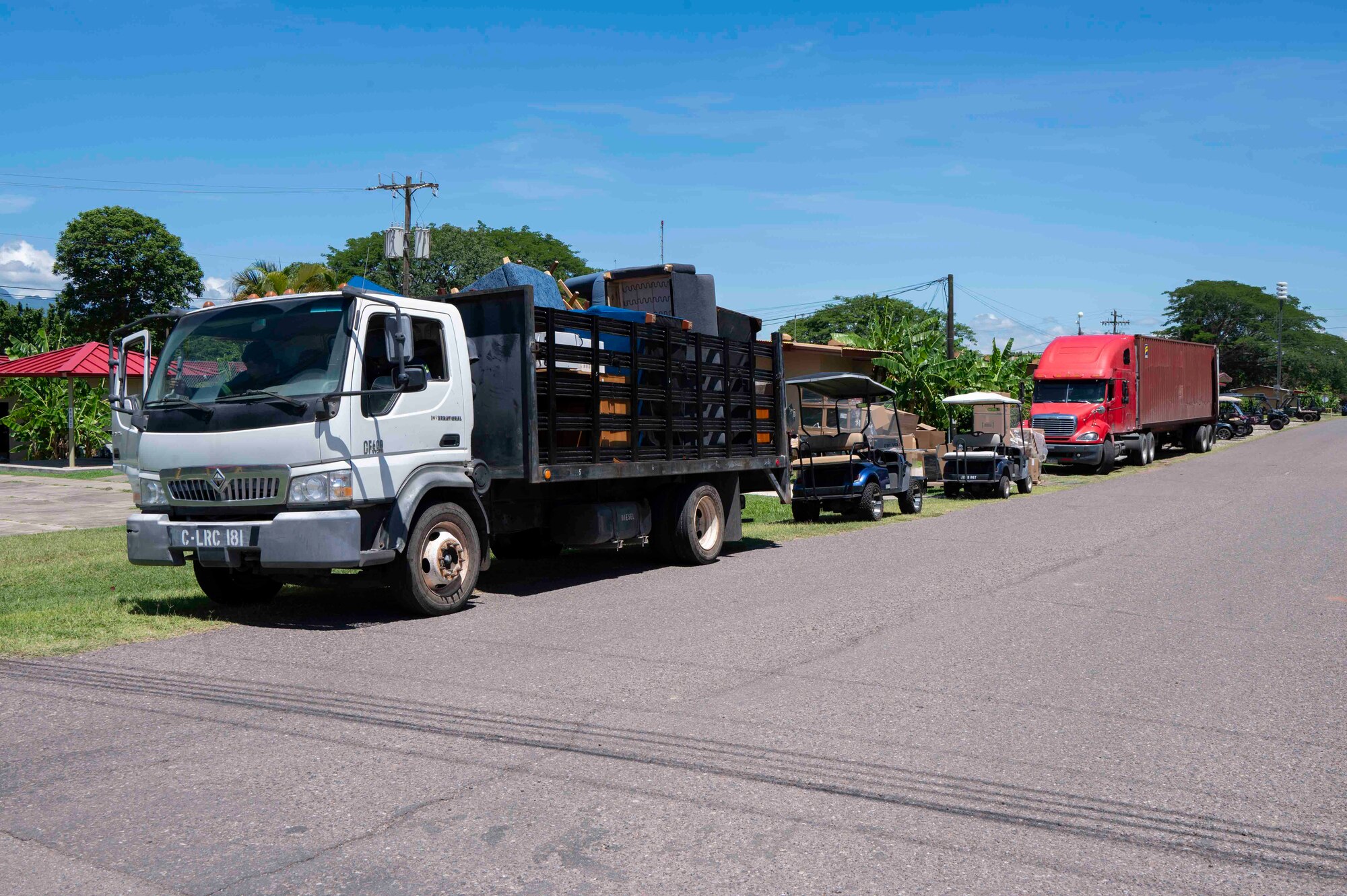A photo of a line of trucks along a road.