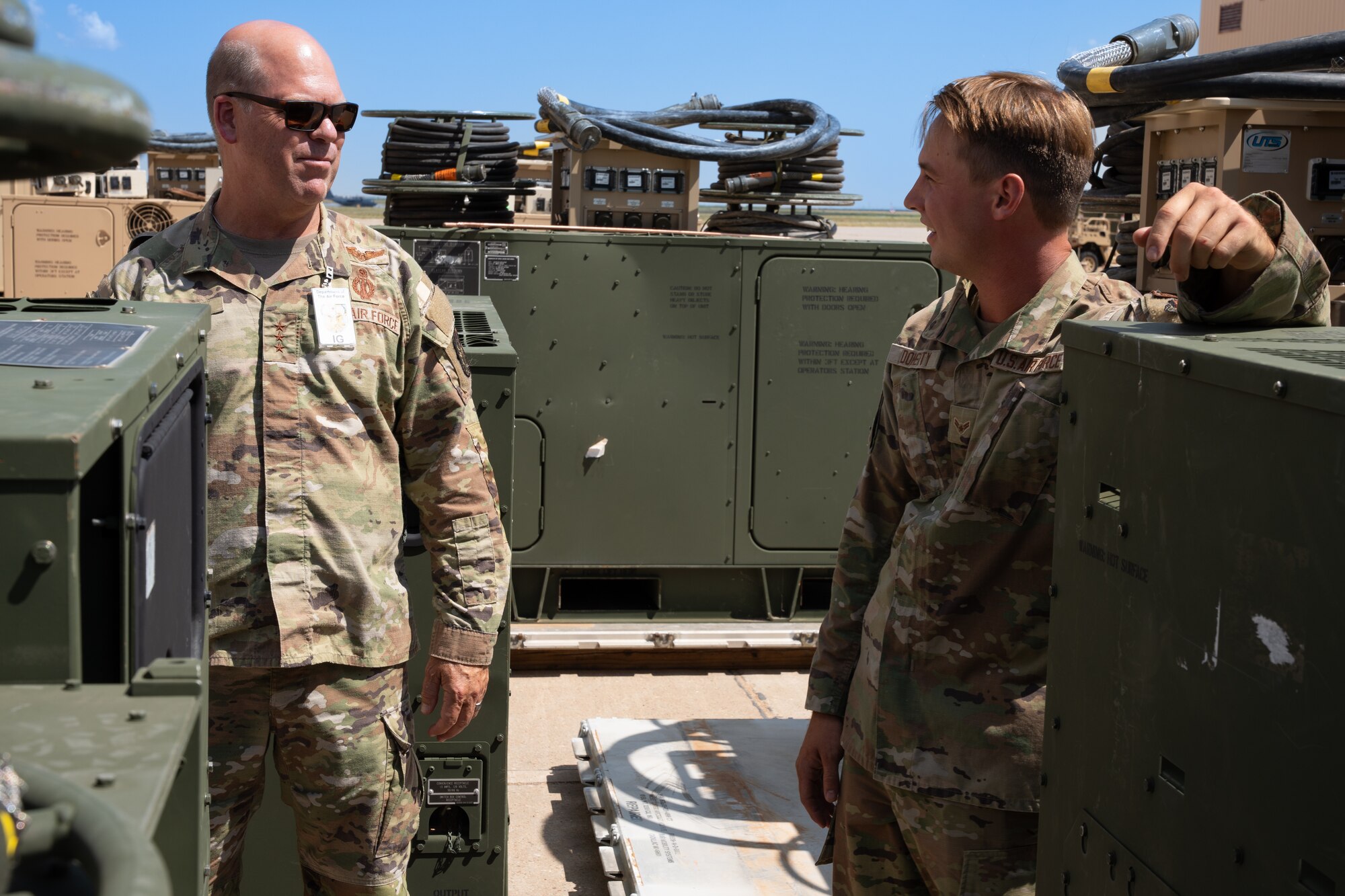 U.S. Air Force Lt. Gen. Stephen Davis, Department of the Air Force Inspector General, speaks with U.S. Air Force Airman 1st Class Zachary Doherty, 27th Special Operations Civil Engineer Squadron electrical power production specialist, Cannon Air Force Base, New Mexico, July 30, 2024. Davis reports to the Secretary of the Air Force, the Chief of Staff of the Air Force and the Chief of Space Operations on matters concerning DAF readiness, efficiency and the military discipline of the total force. (U.S. Air Force photo by Airman 1st Class Tori Shearn)