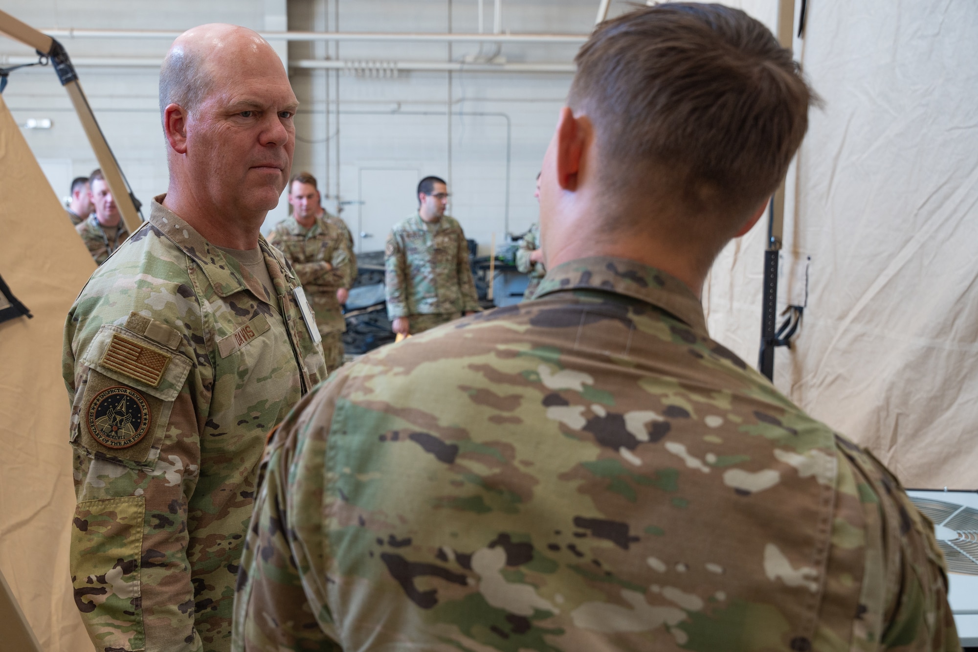 U.S. Air Force Lt. Gen. Stephen Davis, Department of the Air Force Inspector General, speaks with a member of the 27th Special Operations Wing Mission Sustainment Team, Cannon Air Force Base, New Mexico, July 30, 2024. Mission Sustainment Teams create mission ready Airmen prepared to sustain living conditions required to generate unconventional air power in complex deployed environments. (U.S. Air Force by Airman 1st Class Tori Shearn)