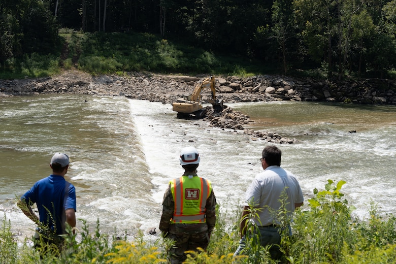 Louisville District Commander Col. L. Reyn Mann (center) and The Nature Conservancy and US Fish and Wildlife Service partners watch the removal of Green River Dam 5 along the Green River in Brownsville, Kentucky, Aug. 23, 2024. As of late August, 75 percent of the dam has been removed.