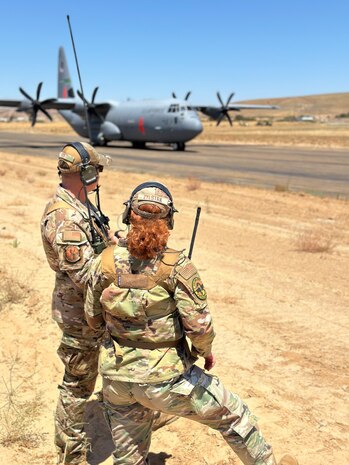 U.S. Air Force Tech. Sgt. David Rost, 9th Operational Support Squadron landing zone controller, and Senior Airman Kathryn Zylstra, 9th OSS landing zone safety officer, from Beale Air Force Base, scan their Landing Zone surface to ensure the safe departure of a C-130J Super Hercules from the 146th Airlift Wing, Channel Islands Air National Guard Station, from the Landing Zone at Camp Roberts, California, Aug. 8, 2024.