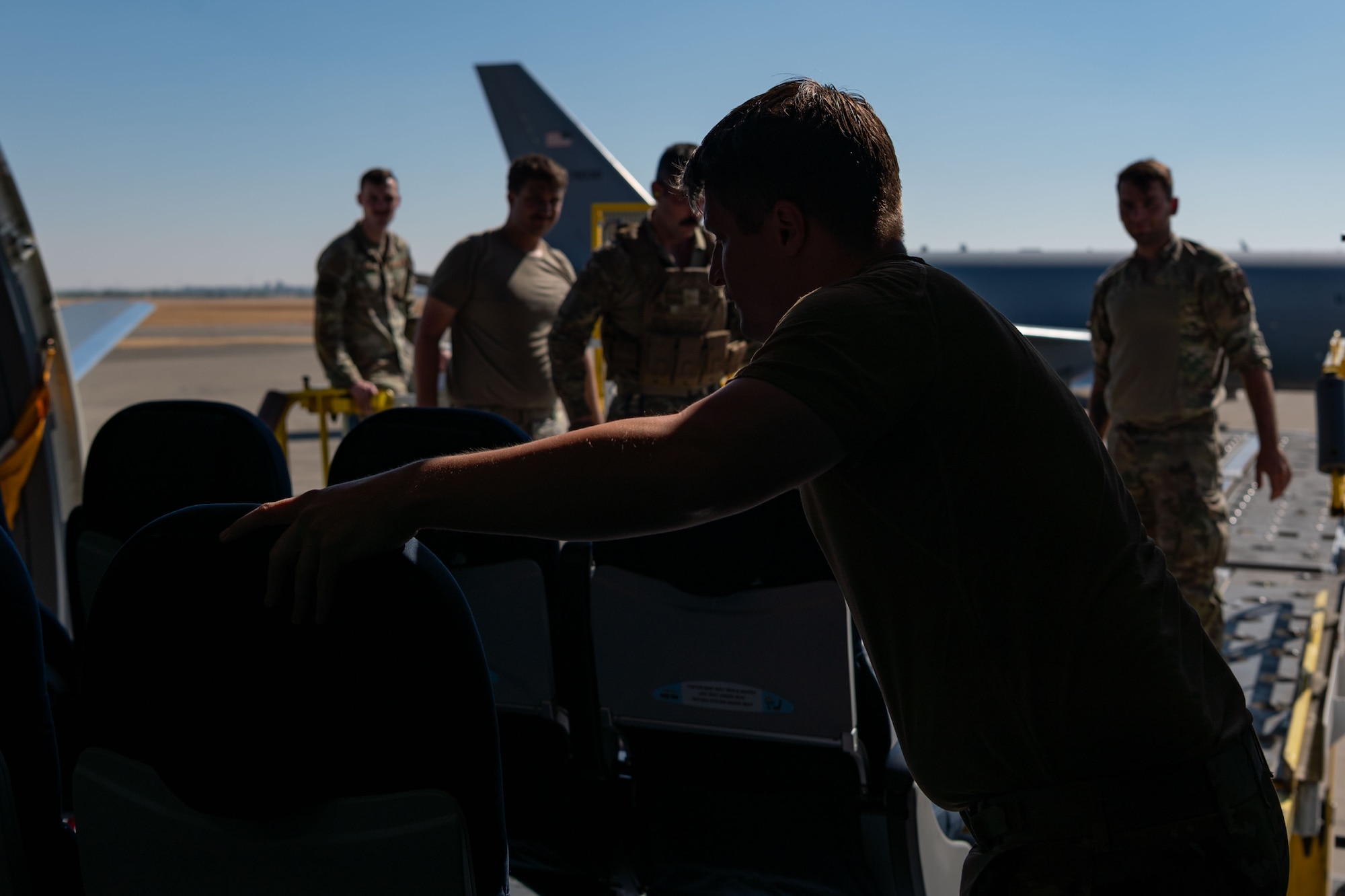 U.S. Air Force Tech. Sgt. Keifer Bowes, 32nd Air Refueling Squadron instructor boom operator, loads cargo onto a KC-46 Pegasus during exercise Bamboo Eagle 24-3 at Mather Airport, Sacramento, Calif., Aug. 9, 2024. As part of the 305th Air Mobility Wing, the 32nd ARS operates the KC-46 Pegasus aircraft conducting air refueling missions necessary to support air mobility missions on a global scale. During BE 24-3, Air Mobility Command assets supported warfighters implementing all-domain combat-power generation from disaggregated basing locations throughout the western part of the U.S., along with distributed command and control, agile logistics and tactical air-to-air refueling. Bamboo Eagle provides participating units opportunities to highlight Air Force efforts to reoptimize for Great Power Competition and to focus on mission readiness to deliver cross-functional and lethal combat capabilities with the speed and agility required to meet pacing challenges. (U.S. Air Force photo by Staff Sgt. Monica Roybal)