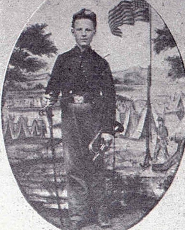 An old photograph shows a young boy holding a bugle beside an American flag.