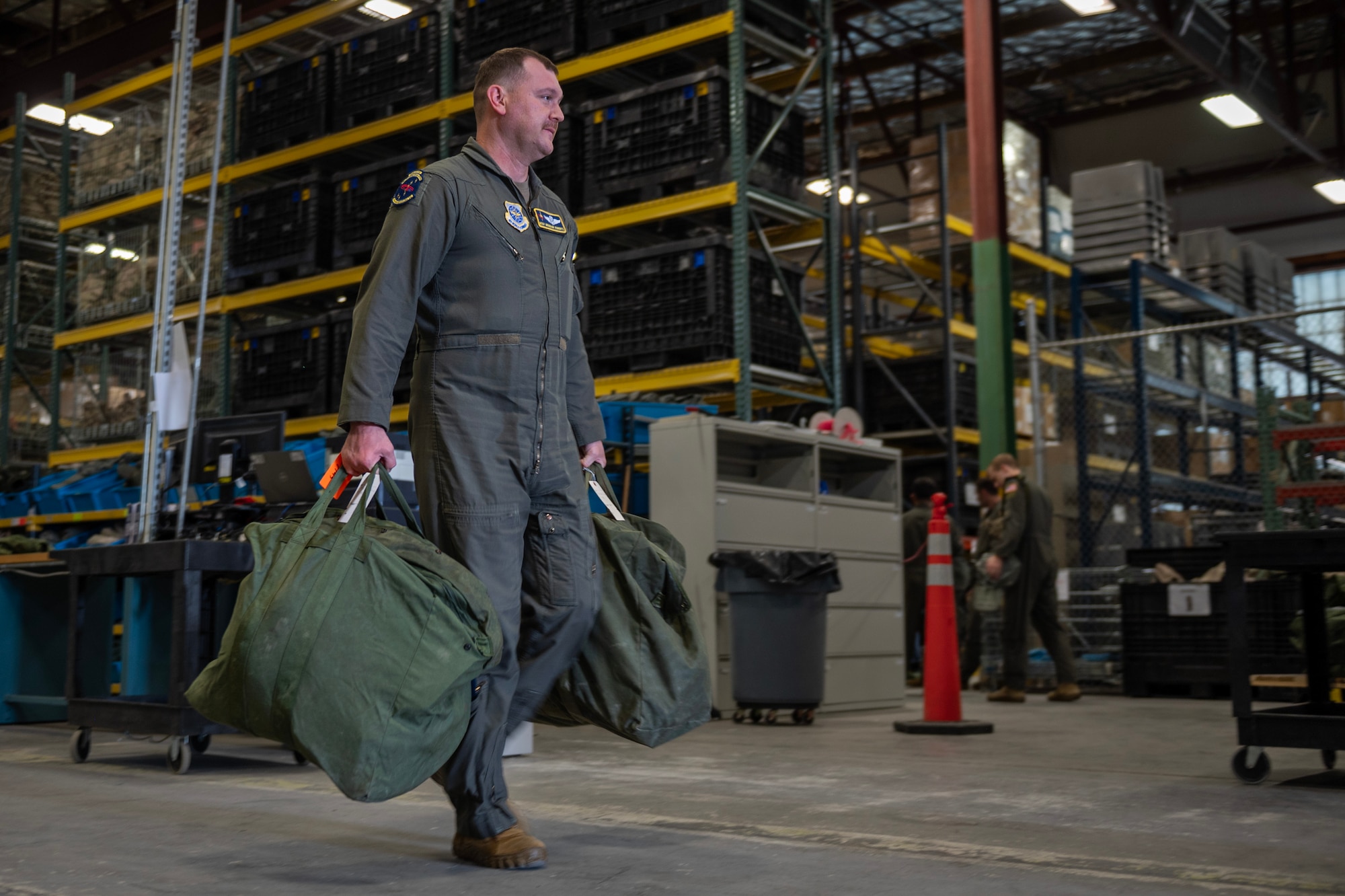 Master Sgt. Brandon Roberts, 97th Air Refueling Squadron chief of standards and evaluation, carries his deployment bags at Fairchild Air Force Base, Washington, Aug. 9, 2024. Airmen receive multiple bags containing various clothing items and gear that they may need in a deployed environment. Airmen assigned to the 92nd Air Refueling Wing deployed outside of the normal Air Force Force Generation cycle as part of U.S. force posture changes in the U.S. Central Command area of responsibility to mitigate the possibility of regional escalation. (U.S. Air Force photo by Senior Airman St Marks)