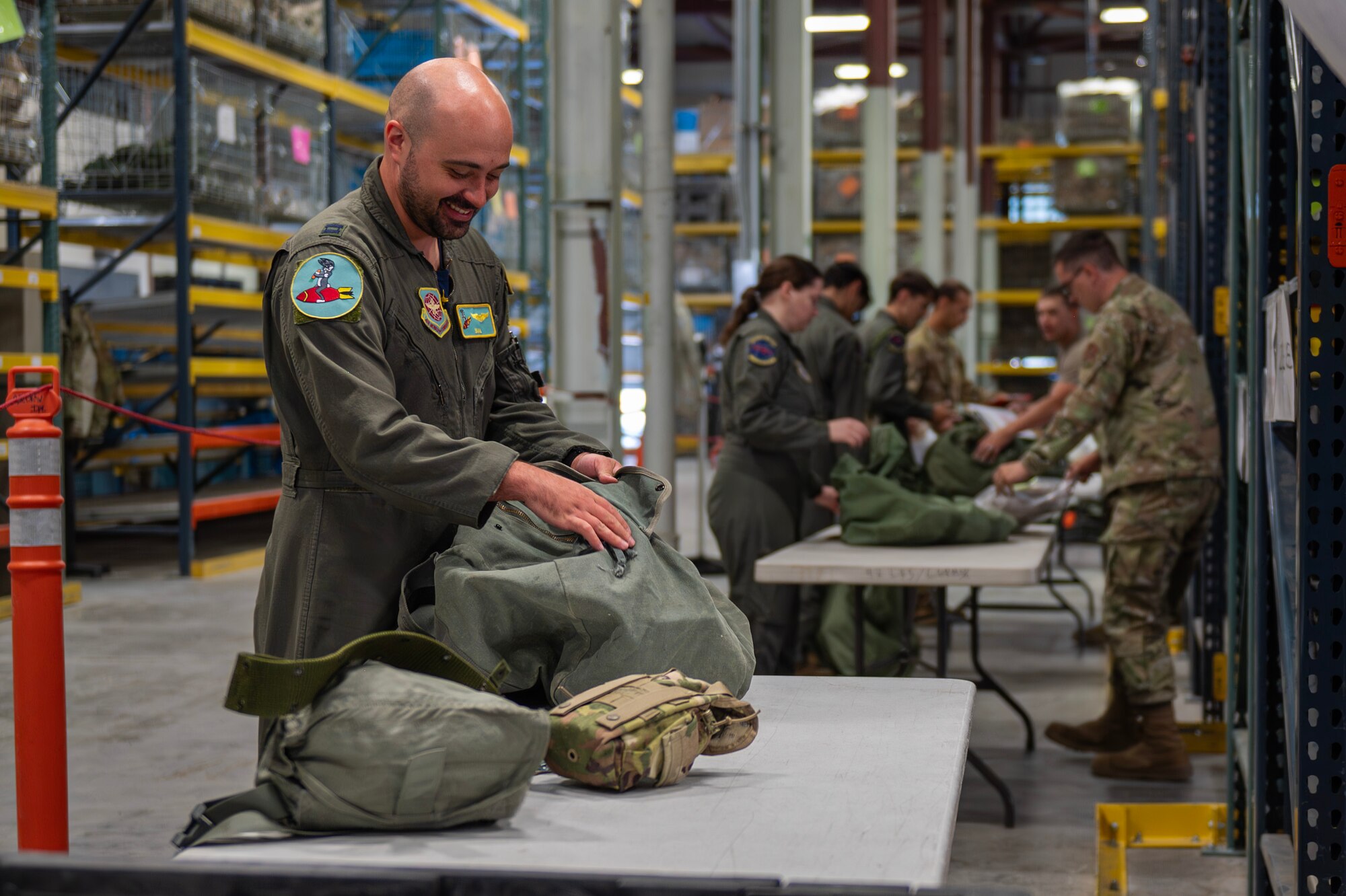 Capt. Nicholas Saal, 97th Air Refueling Squadron tactics officers, packs items into his deployment bags at Fairchild Air Force Base, Washington, Aug. 9, 2024. Airmen receive multiple bags containing various clothing items and gear that they may need in a deployed environment. Airmen assigned to the 92nd Air Refueling Wing deployed outside of the normal Air Force Force Generation cycle as part of U.S. force posture changes in the U.S. Central Command area of responsibility to mitigate the possibility of regional escalation.  (U.S. Air Force photo by Senior Airman St Marks)