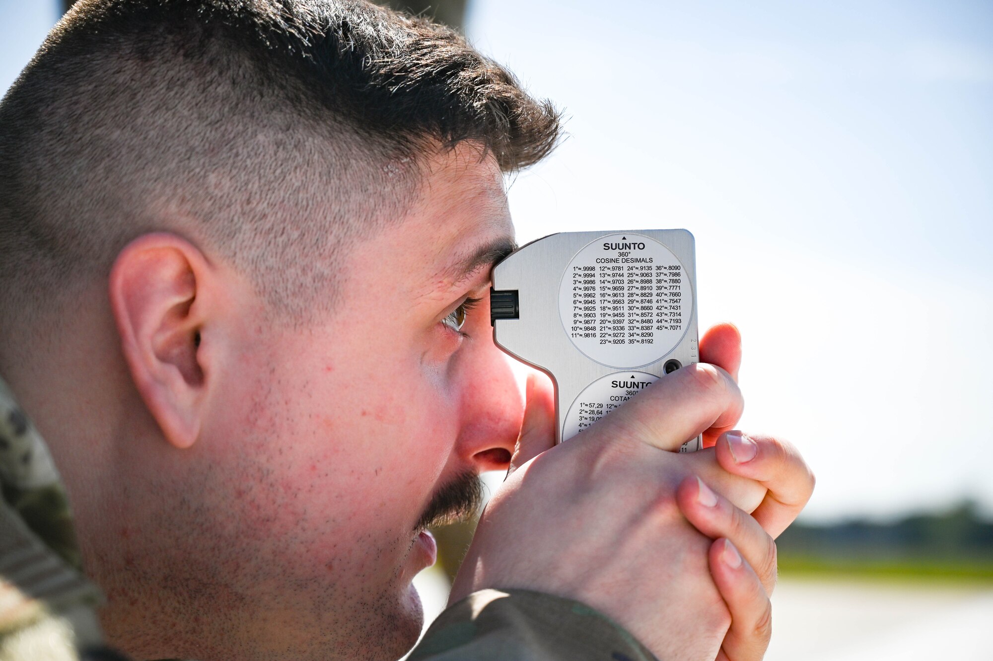 An Airman uses a clinometer on the flight line.