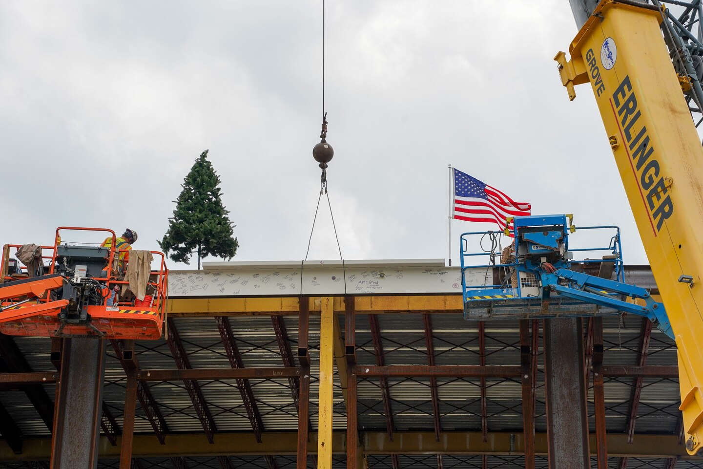 The highest piece of structural steel is placed atop the Air Mobility Command Headquarters building, July 31, 2024, at Scott Air Force Base, Illinois.