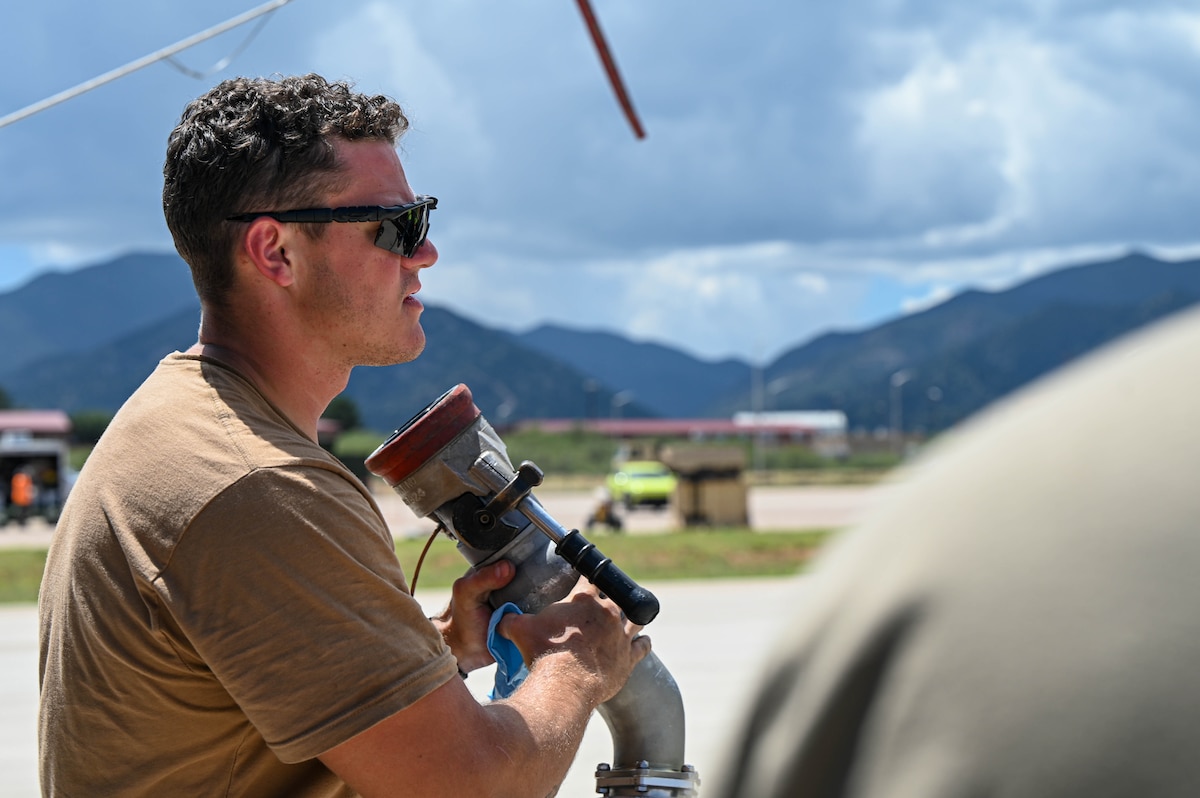 U.S. Air Force Staff Sgt. Jonathan Mitchell, 55th Rescue Generation Squadron crew chief dismounts a fuel cable at Fort Huachuca, Arizona, Aug. 27, 2024. The team replaced engine parts and refueled two HH-60W helicopters during exercise Mosaic Lightning. (U.S. Air Force photo by Senior Airman Andrew Garavito)