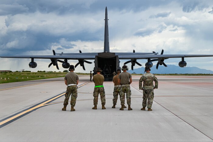 U.S. Air Force Airmen await a C-130 Hercules to begin unloading equipment in support of exercise Mosaic Lightning at Fort Huachuca, Arizona, Aug. 27, 2024. Performing military exercises tests the reaction and response time of military members, allowing the team to learn and grow together. (U.S. Air Force photo by Senior Airman Andrew Garavito)