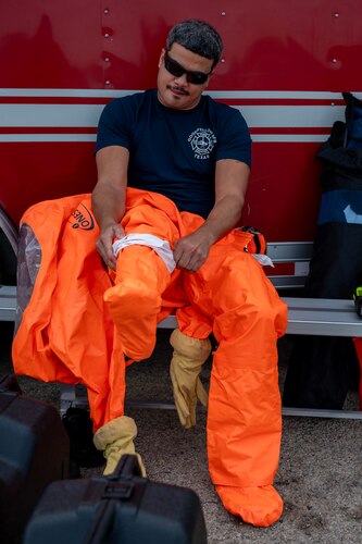 Acosta Radhames, 17th Civil Engineer Squadron firefighter, dons his personal protective equipment at the Spur Arena, San Angelo, Texas, Aug. 27, 2024. Using PPE during a hazmat event shields responders from dangerous substances, minimizing the risk of exposure and ensuring their safety while managing the incident. (U.S. Air Force photo by Senior Airman Sarah Williams)