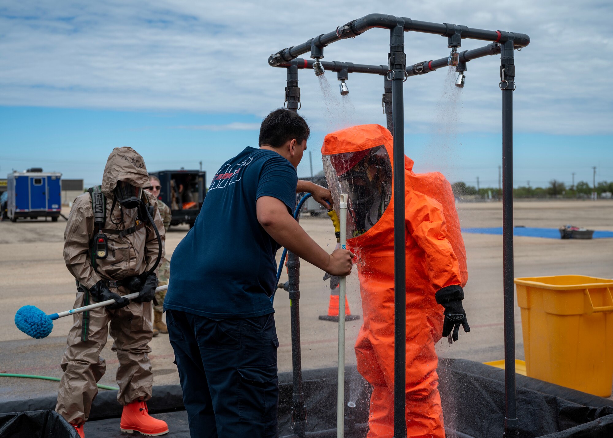 U.S. Air Force Senior Airman Esol Hoang, 17th Civil Engineer Squadron emergency management, showers in the decontamination zone at the Spur Arena, San Angelo, Texas, Aug. 27, 2024. Decontamination eliminates hazardous substances, protecting first responders and the public from potential exposure and preventing the spread of contamination. (U.S. Air Force photo by Senior Airman Sarah Williams)