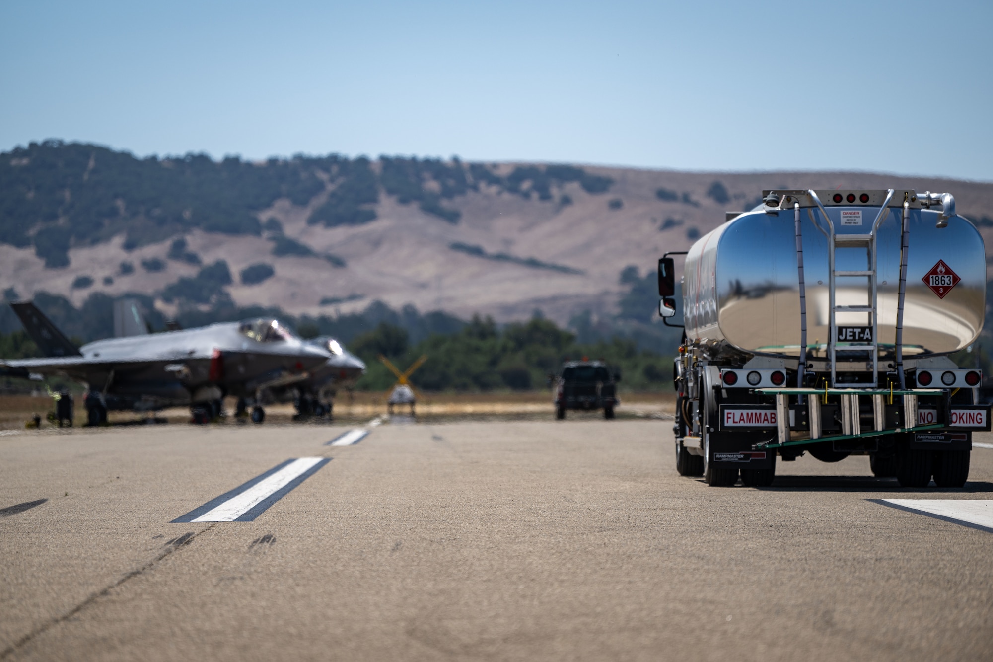 A U.S. Air Force Petroleum Oil and Lubricant truck drives down a tarmac during Exercise Agile Flag 24-3 in Santa Maria, California, Aug. 5, 2024. During AGILE FLAG 24-3, the 23rd Wing provided the Air Expeditionary Wing leadership element, the Command-and-Control Force Element, and the Air Base Squadron at two separate locations exercising rapid insertion into theaters, establishing logistics and communications with theater C2, receipt of follow-on forces, mission generation, and combat power projection across all domains, while making critical decisions needed to remain agile. (U.S. Air Force photo by 2nd Lt. Benjamin Williams)