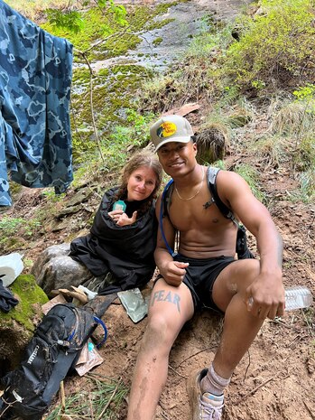 Airman posing for a photo with woman he rescued from flash flood