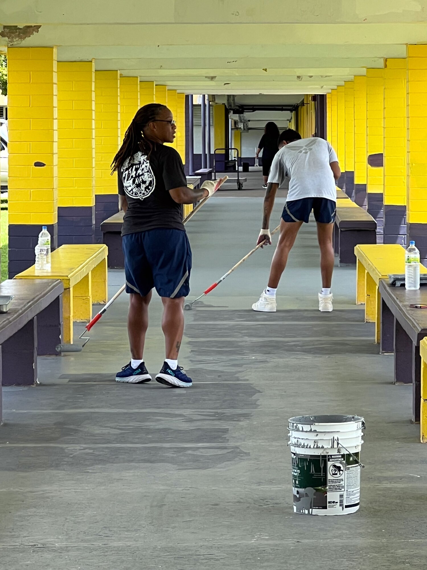 U.S. Air Force Airmen from the 734th Air Mobility Squadron paint the breezeway.