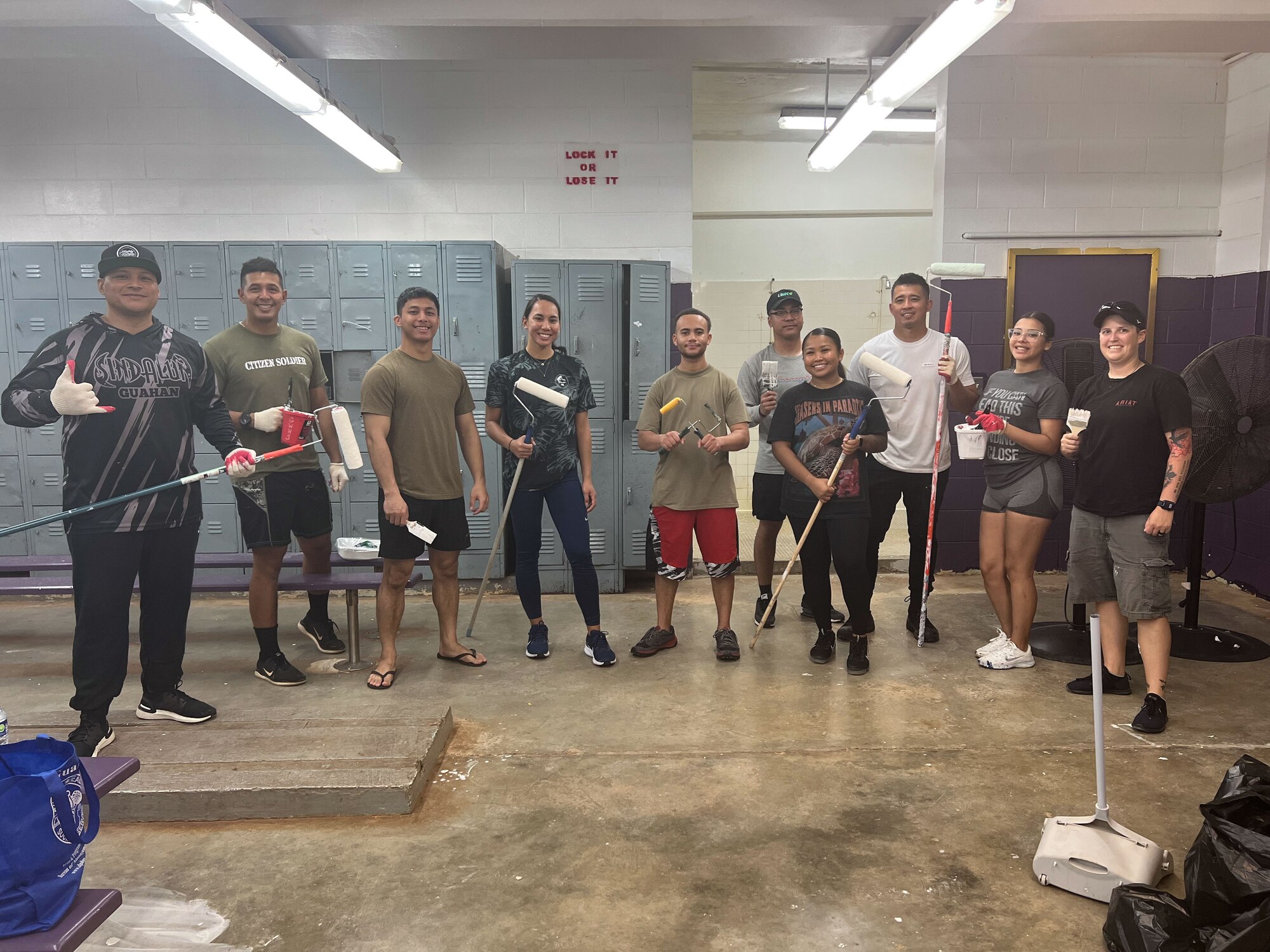 U.S. Airmen from the 36th Wing pose for a group photo in civilian attire during a cleaning.