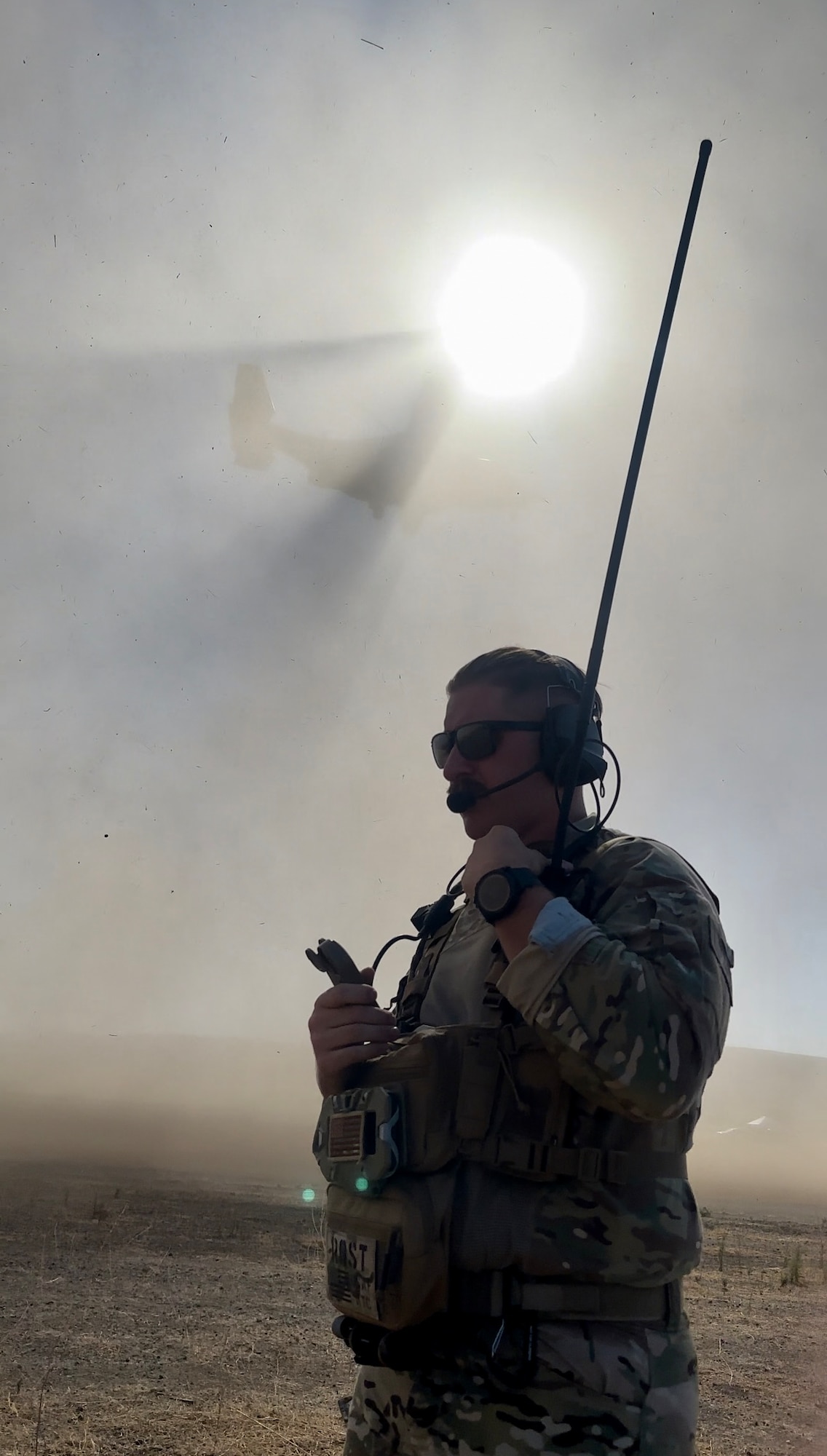 U.S. Air Force Tech. Sgt. David Rost, 9th Operational Support Squadron landing zone controller from Beale Air Force Base, issues a “Go-Around” instruction to a Navy C-V22 Osprey due to reduced visibility or a “brown-out” on a landing attempt on the Landing Zone at Camp Roberts, California, Aug. 8, 2024.