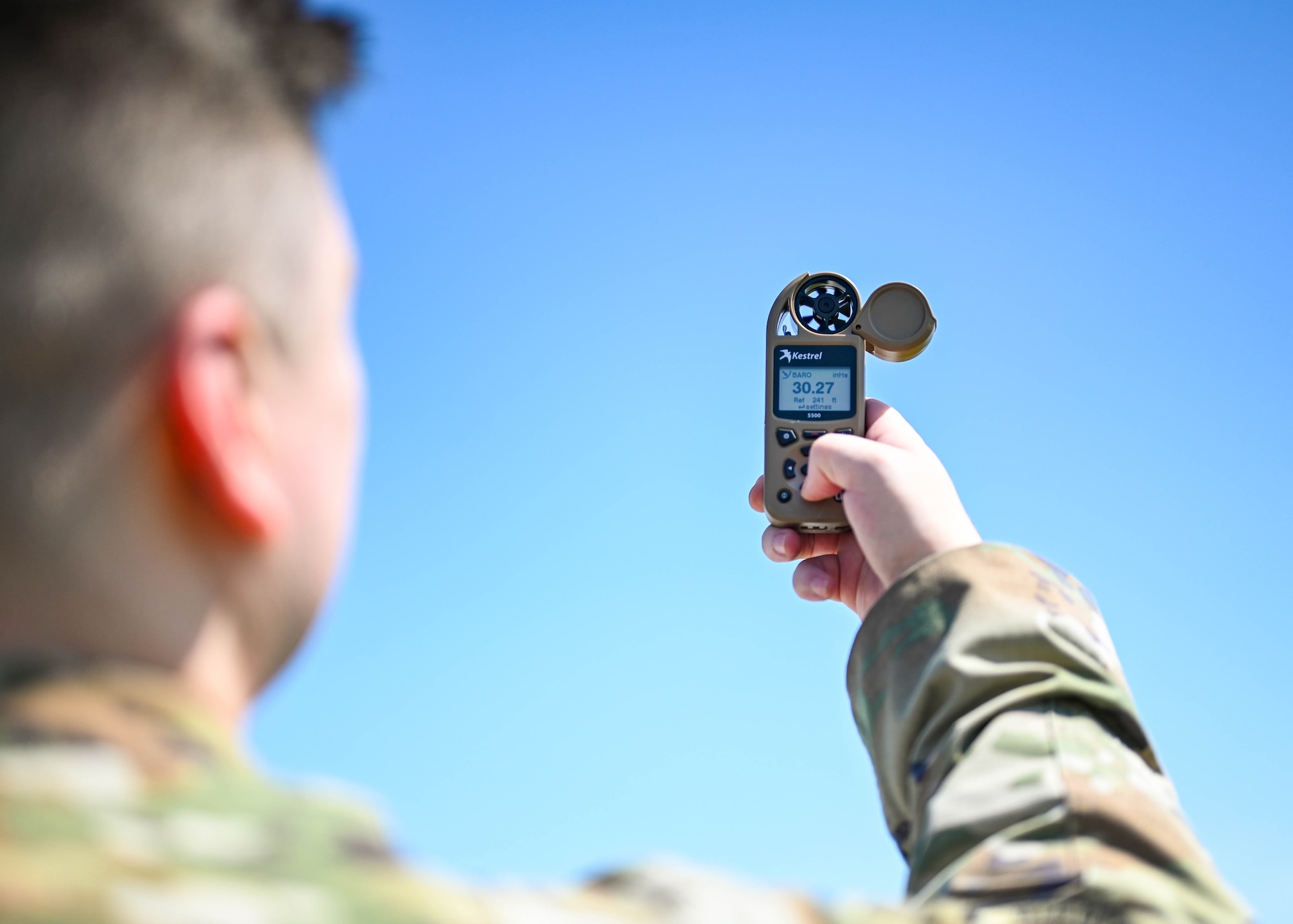 An Airman uses a weather meter on the flight line.
