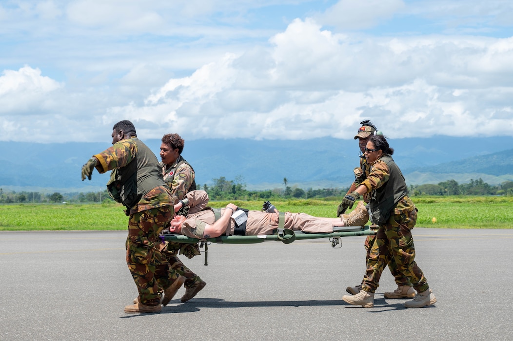 Papua New Guinea Defence Force medical personnel transport a “patient” between aircraft during Pacific Angel 24-1 at Nadzab Tomodachi International Airport, Papua New Guinea, Aug. 29, 2024.