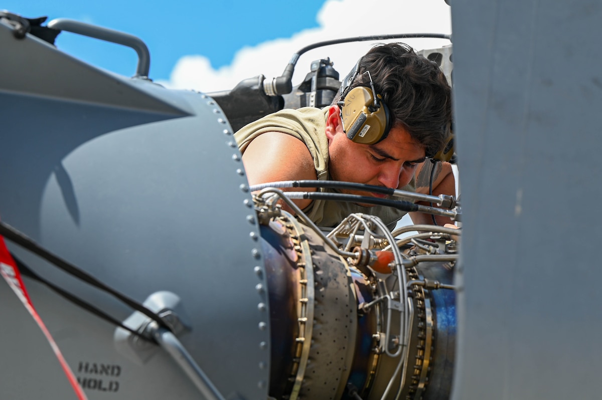 U.S. Air Force Staff Sgt. David Devincenzi, 55th Rescue Generation Squadron avionics technician removes parts from an HH-60W helicopter at Fort Huachuca, Arizona, Aug. 27, 2024. The group of technicians were split into two shifts during the exercise to ensure mission capabilities did not fail. (U.S. Air Force photo by Senior Airman Andrew Garavito)