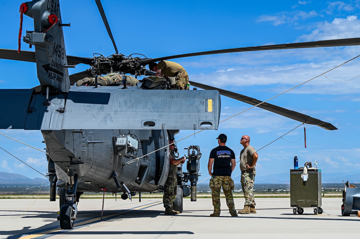 U.S. Air Force Airmen work on an HH-60W helicopter during an exercise at Fort Huachuca, Arizona, Aug. 27, 2024. This event was part of a much larger exercise, Mosaic Lightning, testing the capabilities of mission personnel. (U.S. Air Force photo by Senior Airman Andrew Garavito)
