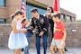 A man's children and wife pin on his new rank.