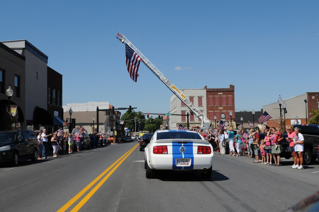 Local citizens line Main Street in downtown Greenville, Ky., to welcome home the soldiers of 176th Engineer Firefighting Team, Sept. 11, 2012. The unit deployed to Afghanistan exactly one year before, Sept. 11, 2011.