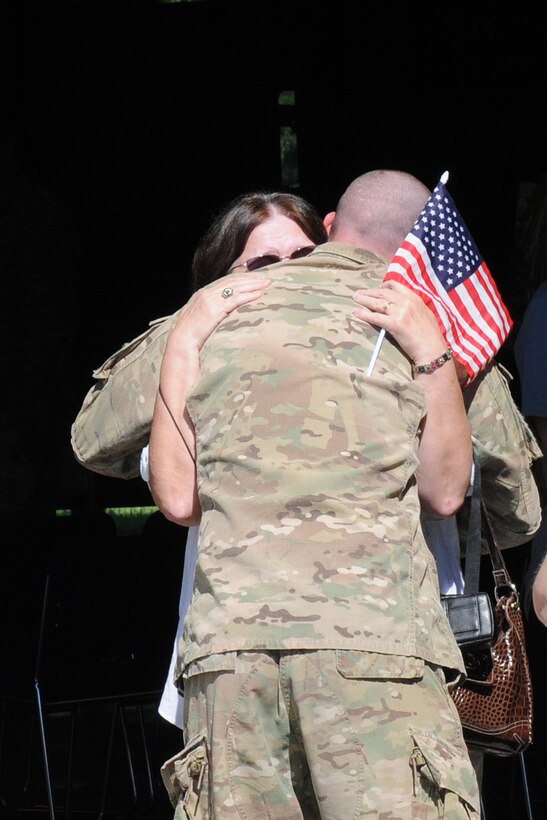 A soldier with the 176th Engineer Firefighting Team embraces a family member at the unit's welcome home ceremony in Greenville, Ky., Sept. 11, 2012. The seven-member team was welcomed home with a parade through the town prior to the ceremony at the Wendell H. Ford Regional Training Center.