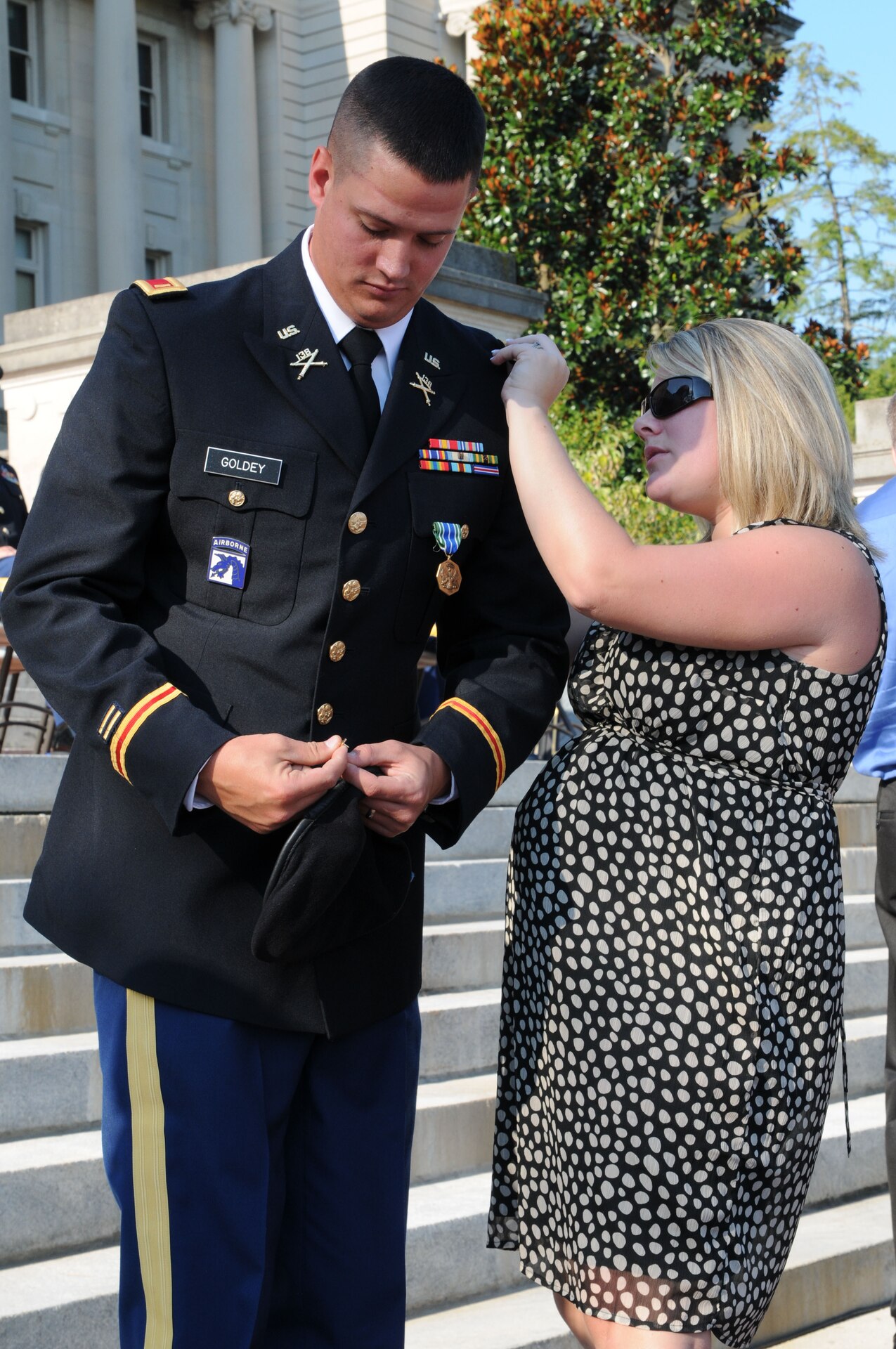 Spouse Courtney Goldey pins her husband, 2nd. Lt. Martin A. Goldey, during the OCS Commissioning Ceremony at the State Capitol in Frankfort, Ky., Aug. 25.