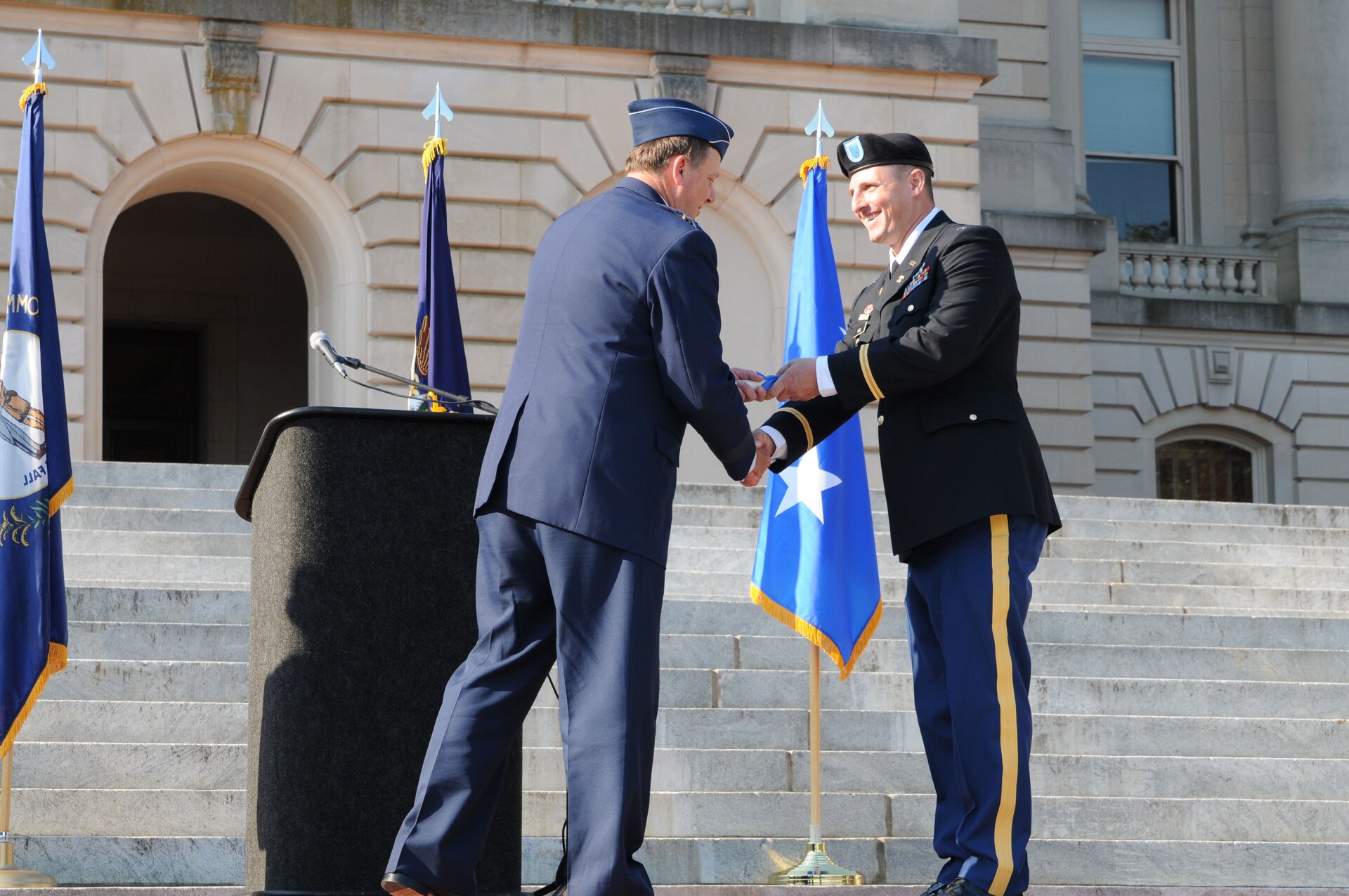 Maj. Gen. Edward W. Tonini, Kentucky's adjutant general, congratulates 2nd. Lt. Scott A. Hill during the 238th Regiment's OCS Commissioning Ceremony at the State Capitol in Frankfort, Ky., Aug 25.