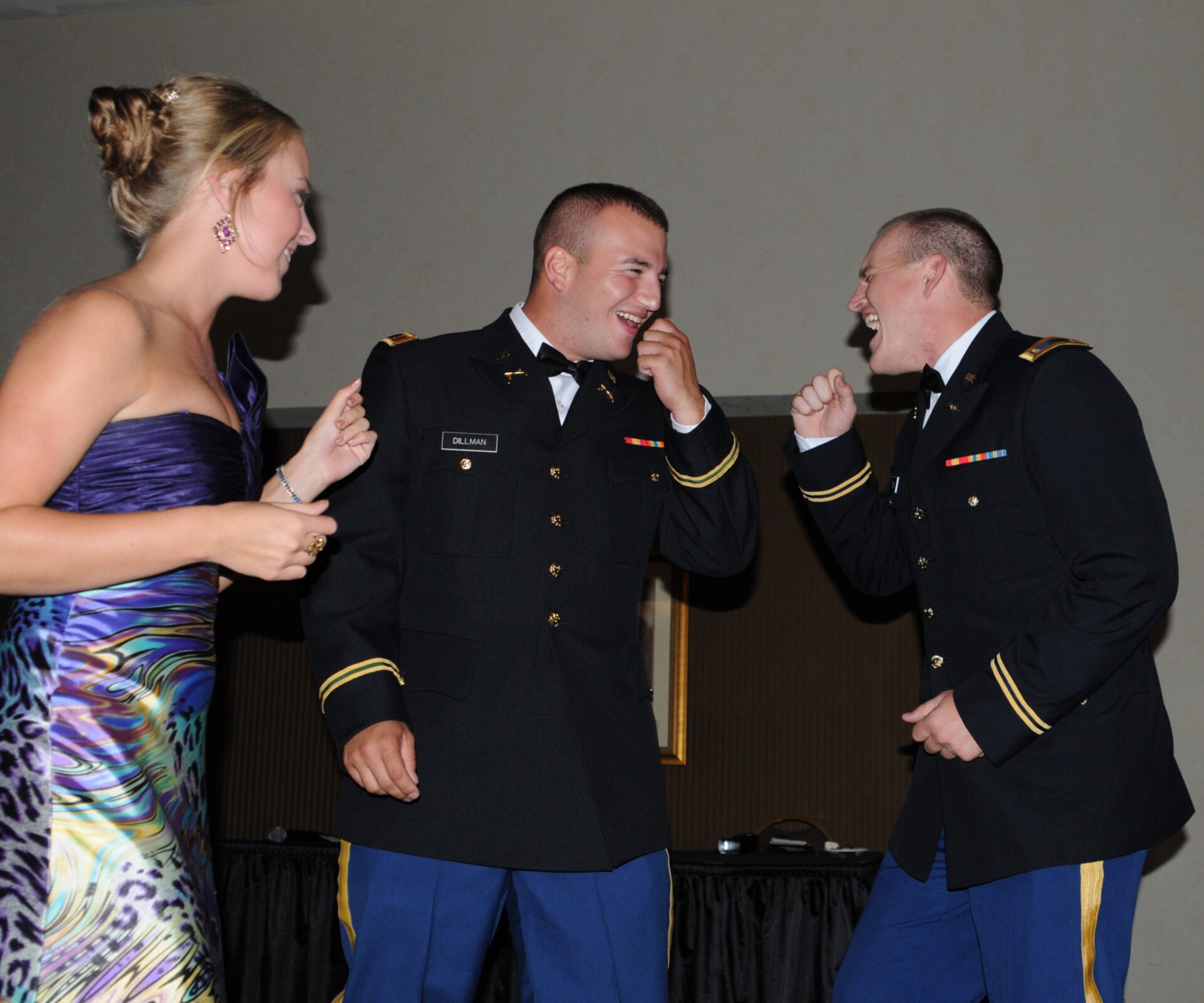Newly commissioned officers Derek Dillman and Christopher Cook dance along with Alycia Lynch at the military ball honoring the recent Officer Candidate School graduates at the Capital Plaza Hotel in Frankfort, Ky., Aug. 25, 2012.