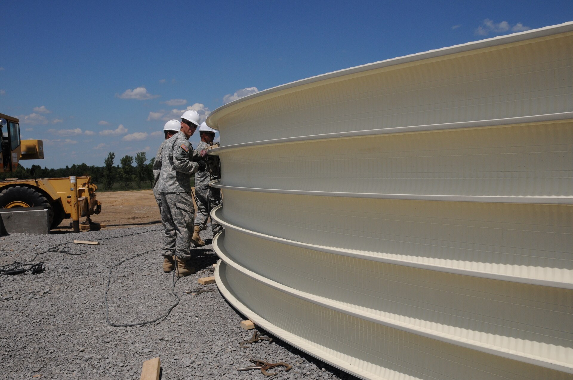 Soldiers of the 149th Vertical Engineer Company connect steel panels to form a section of the roof of a K-span building at Wendell H. Ford Regional Training Center in Greenville, Ky., Aug. 20, 2012.