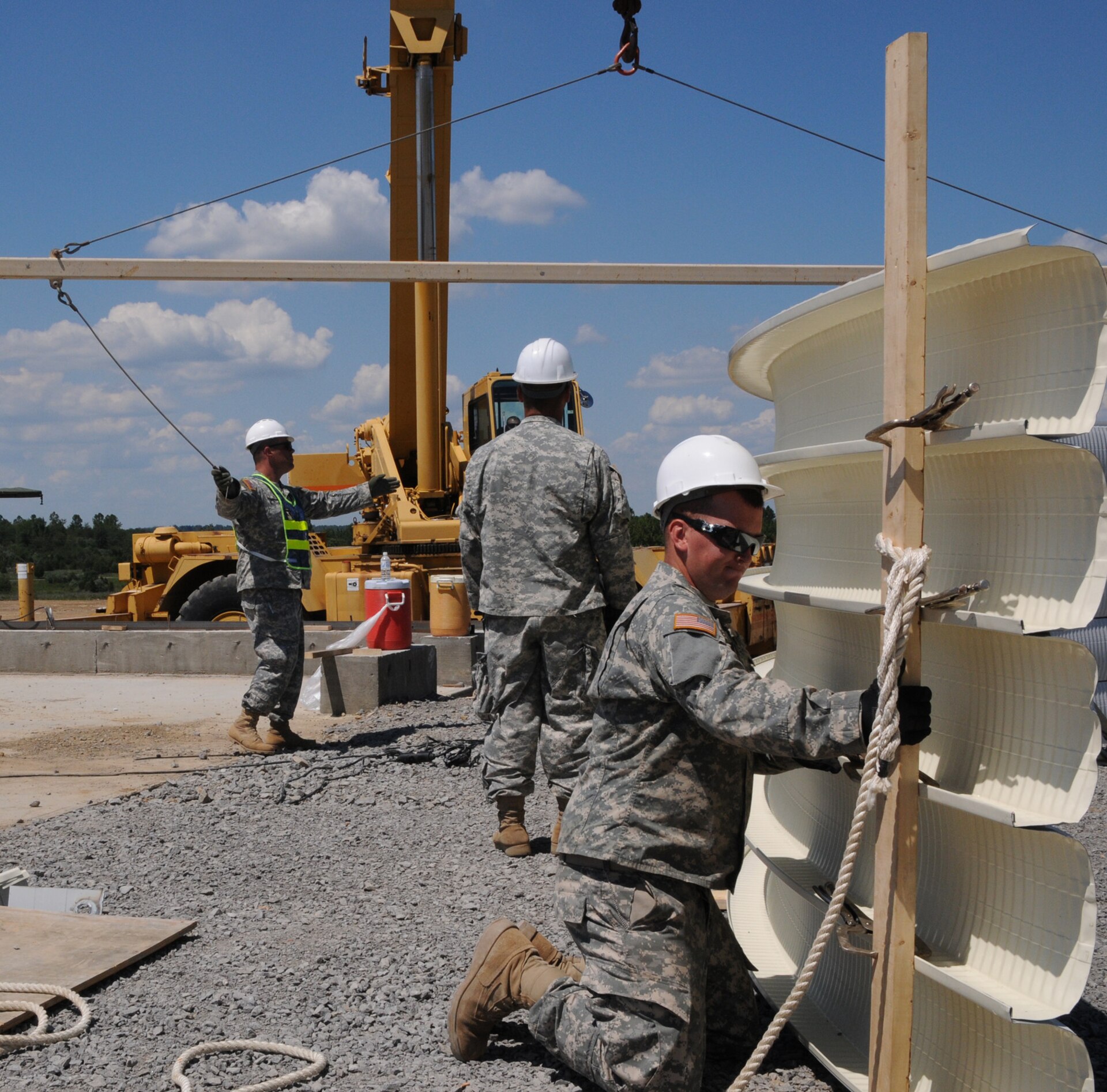 Soldiers of the 149th Vertical Engineer Company assemble steel panels to lift into position as the roof of a K-span building at Wendell H. Ford Regional Training Center in Greenville, Ky., Aug. 20, 2012.