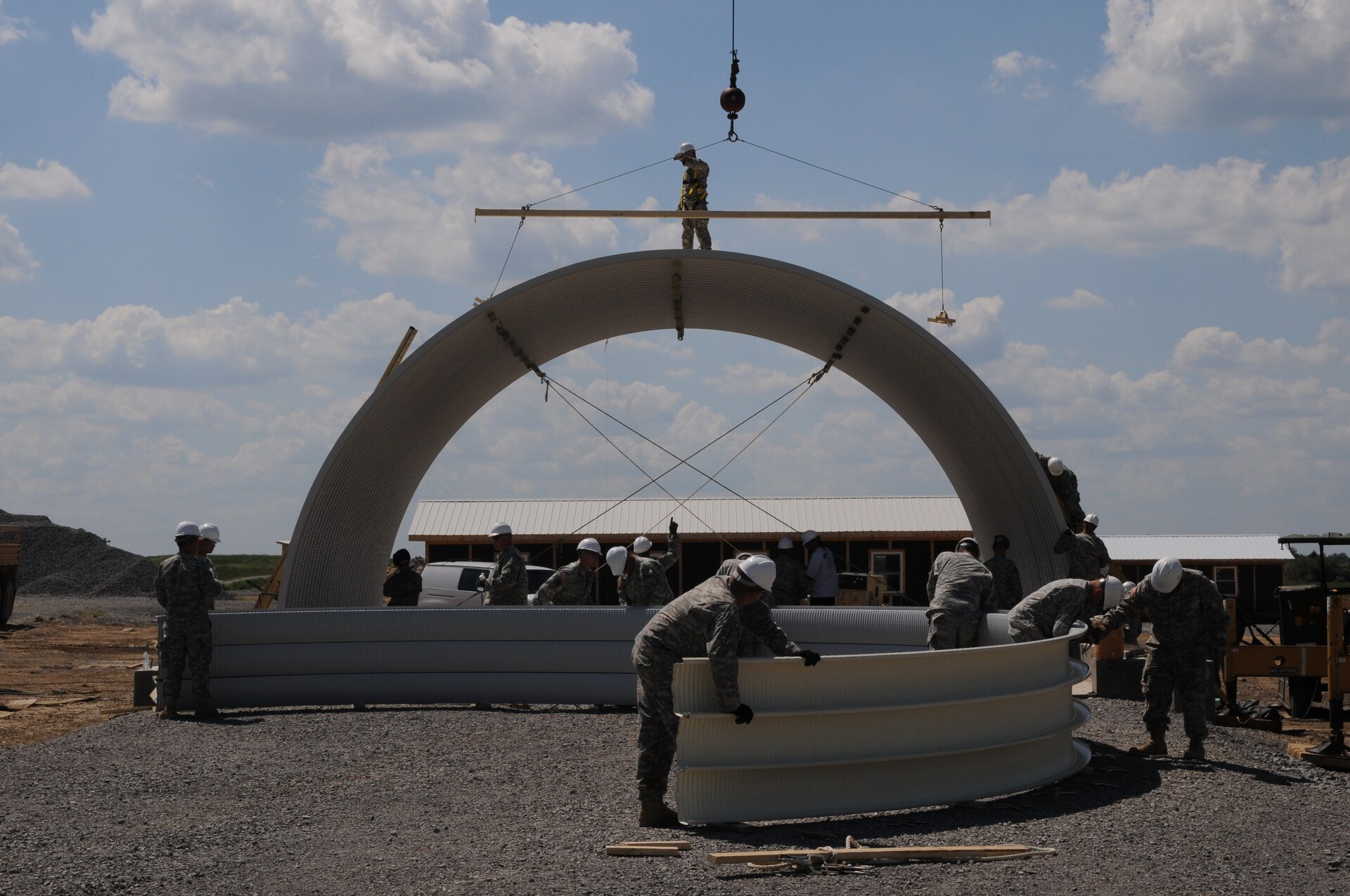 Soldiers of the 149th Vertical Engineer Company assemble steel panels to lift into position as the roof of a K-span building at Wendell H. Ford Regional Training Center in Greenville, Ky., Aug. 20, 2012.