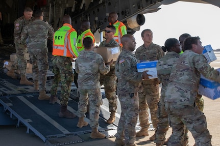 U.S. Army Soldiers with the North Carolina National Guard help unload books to be distributed to several schools across Botswana Aug. 16, 2024. More than 2000 books are being given to the Botswanan Ministry of Education for distribution to elementary, lower secondary and upper secondary schools.