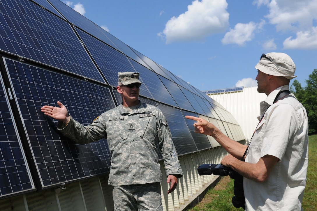 Sgt. 1st Class Chaz Martin, the non-commissioned officer in charge of the Harold L. Disney Training Center, discusses solar panel installation at the site in Artemus, Ky., with a representative of Photon Magazine, June 7, 2012. Photon Magazine visited areas in Kentucky to collect information on solar energy efforts in the Commonwealth.