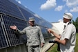 Sgt. 1st Class Chaz Martin, the non-commissioned officer in charge of the Harold L. Disney Training Center, discusses solar panel installation at the site in Artemus, Ky., with a representative of Photon Magazine, June 7, 2012. Photon Magazine visited areas in Kentucky to collect information on solar energy efforts in the Commonwealth.