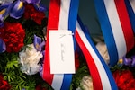 A notecard pinned to a red, white and blue ribbon on a wreath commemorates the birthday of former U.S. President Lyndon B. Johnson following a special ceremony inside the Lyndon B. Johnson National Historical Park visitors center in Stonewall, Texas, Aug. 27, 2024. The Office of the Military Assistant to the U.S. President provides presidential wreaths and arranges for their annual placement at the tombs, burial sites and monuments of all former presidents for special occasions. (U.S. Air Force photo by Senior Airman Gabriel Jones)