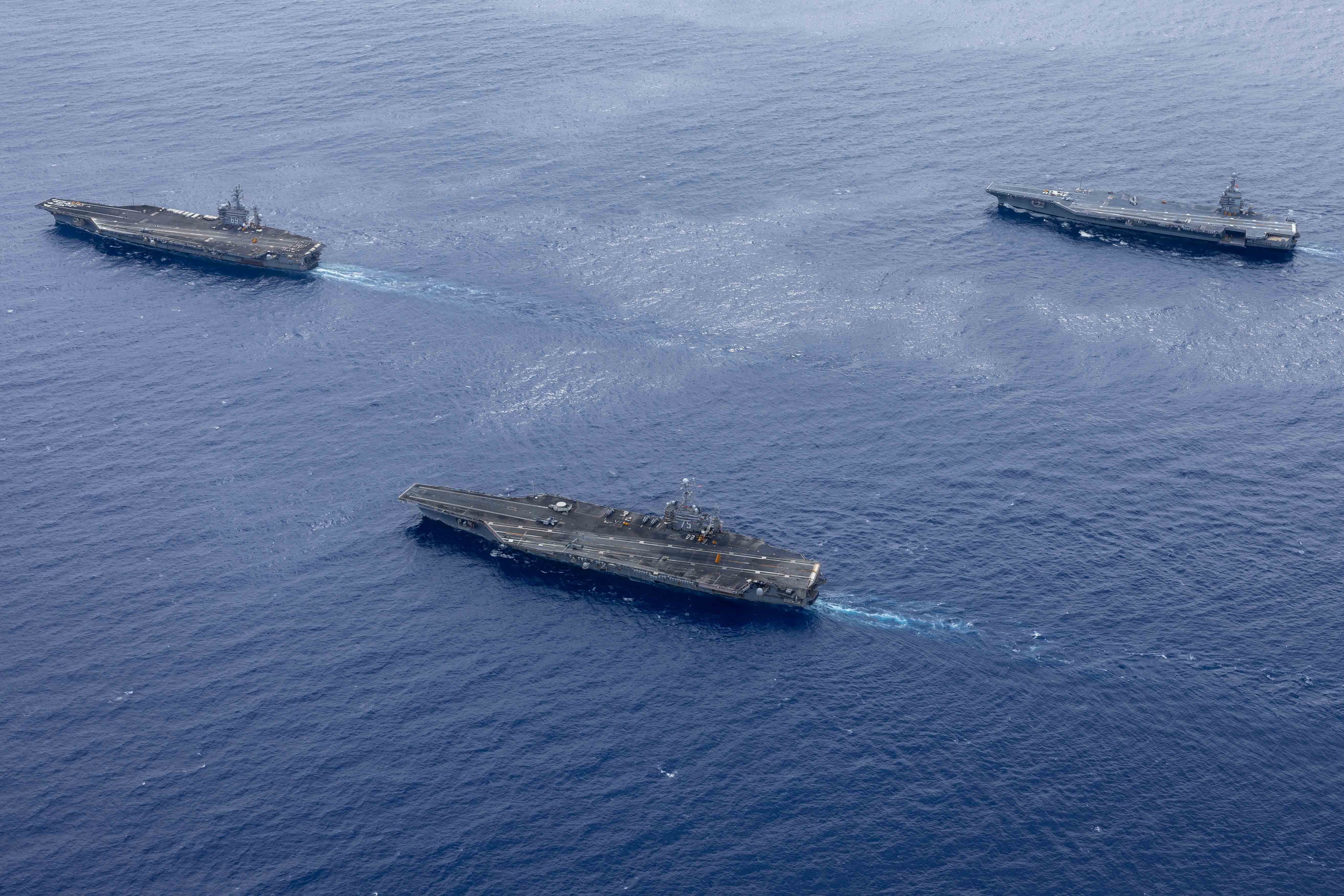 USS Dwight D. Eisenhower (CVN 69), USS Harry S. Truman (CVN 75),  and USS Gerald R. Ford (CVN 78) transit the Atlantic Ocean during an ordnance transfer.surf