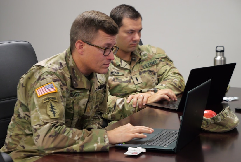 Army Reserve Maj. Matthew Fletcher, data scientist, Mountain View Battalion, Army Applications Group, 75th USARIC and who works as a data scientist in his civilian career, left, and Army Reserve 1st Lt. Joseph Yassin, cloud engineer, Support Group, 75th USARIC and who works as a senior cloud solution architect in his civilian capacity, participate in Code-A-Thon 24, as part of the 75th USARIC’s AAG and SG Artificial Intelligence Team, Aug. 1, 2024 at Fort Liberty, North Carolina in support of the XVIII Airborne Corps