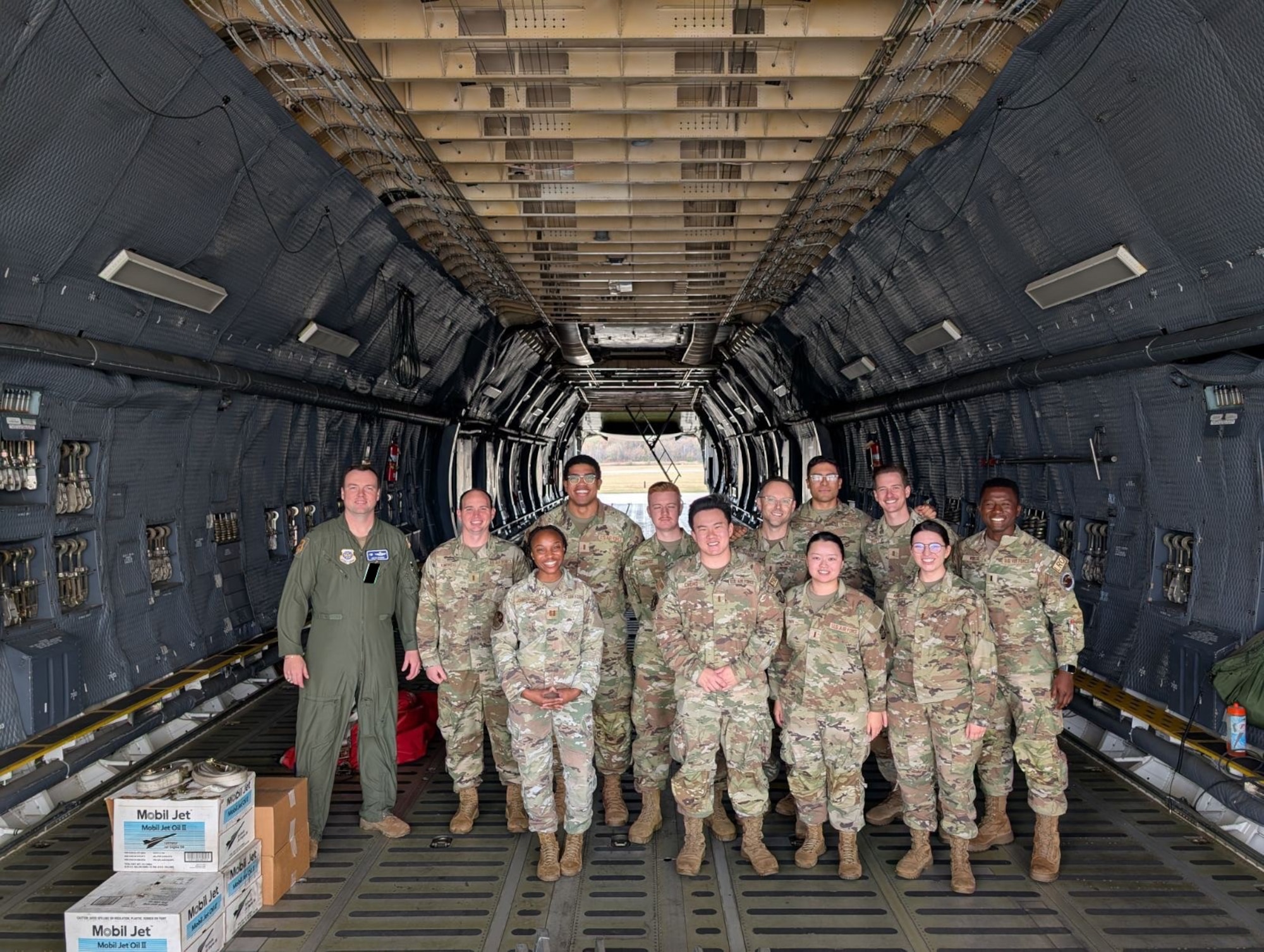 U.S. Air Force Col. Justin Longmire, far left, 436th Airlift Wing deputy commander, poses with First Term Officer Course graduates on a C-5M Super Galaxy at Dover Air Force Base, Delaware, Nov. 1, 2024. The three-day course was geared towards equipping first term officers with essential information for integrating into the 436th AW mission, learning leadership skills and fostering personal development; all while building a supportive network of peer relations. (Courtesy Photo) (This photo has been altered for security purposes by blacking out identification badges.)