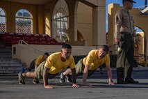 U.S. Marines Corps Capt. Emanuel Garcia, company commander, left, and 1st Sgt. Aaron Scott, company first sergeant, right, with Golf Company, 2nd Recruit Training Battalion, conduct push-ups prior to the company motivational run at Marine Corps Recruit Depot San Diego, California, Nov. 25, 2024. The company motivational run is a three-mile cadence run conducted around the Depot, the last physical training event the Marines will conduct before they graduate from MCRD San Diego and the first time their friends and families will see their newly transformed U.S. Marines. (U.S. Marine Corps photo by Cpl. Alexandra M. Earl)