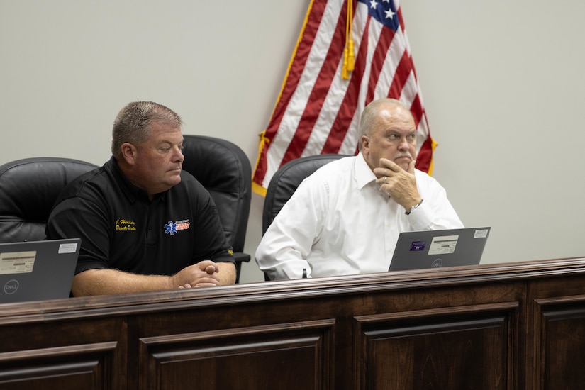 John Hendricks, Nelson County Emergency Management deputy director, and Nelson County Judge Executive Tim Hutchins listen to a presentation by members of the Kentucky National Guard County Outreach Team at a meeting in Bardstown, Nov. 19. Members of the team speak about emergency planning and to identify any shortfalls in resources where the Guard can assist. (U.S. Army National Guard Photo by Milt Spalding)