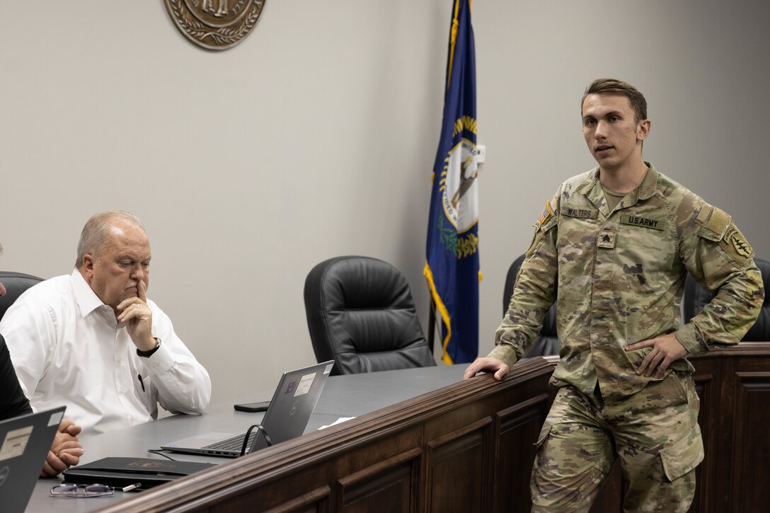 Sgt. Sam Walters speaks to county officials during a presentation in Bardstown, Nov. 19. Members of the Kentucky National Guard County Outreach Team speak to Nelson County Emergency Management and elected officials about emergency planning and to identify any shortfalls in resources where the Guard can assist. (U.S. Army National Guard Photo by Milt Spalding)