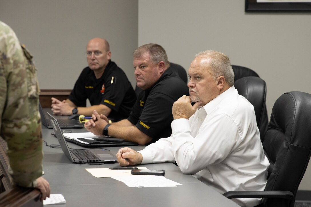 Nelson County Emergency Management Director Brad Metcalf, Deputy Director John Hendricks and Judge Executive Tim Hutchins listen to a presentation in Bardstown, Nov. 19. Members of the Kentucky National Guard County Outreach Team speak to Nelson County Emergency Management and elected officials about emergency planning and to identify any shortfalls in resources where the Guard can assist. (U.S. Army National Guard Photo by Milt Spalding)