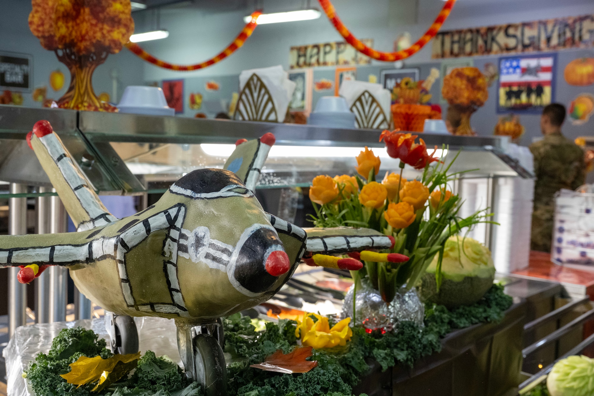 A decoration modeling an F-35 aircraft sits on display in a dining facility.